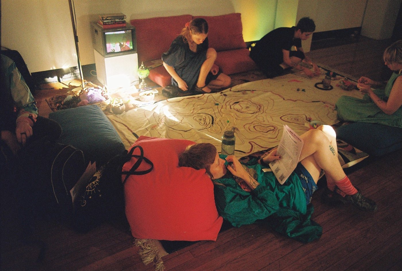 Visitors resting and working around the floor map in the evening